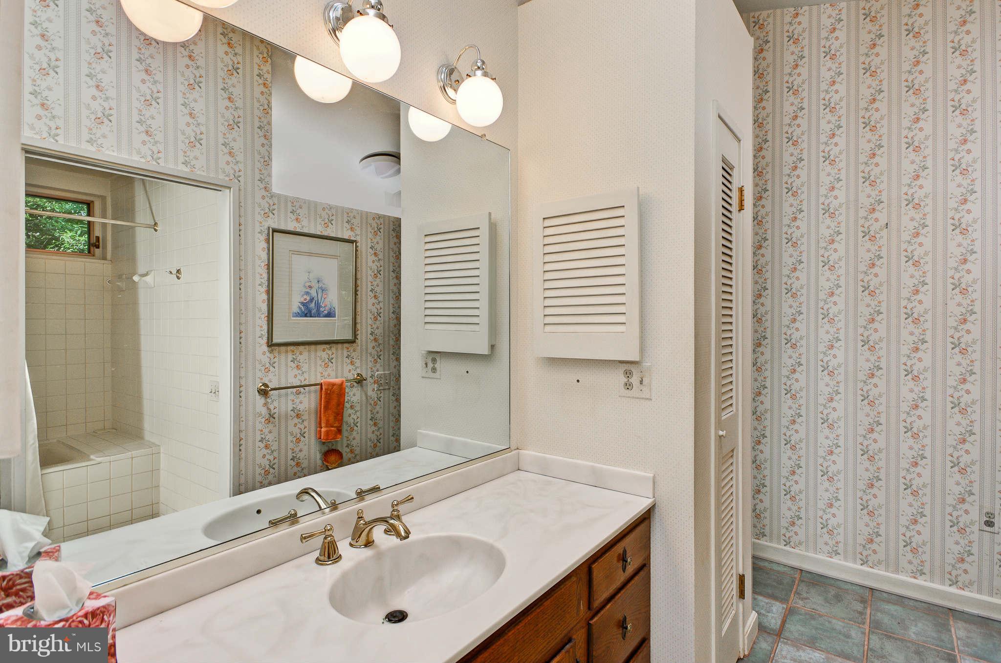 7308 Stafford Road Alexandria, VA 22307 - Photo 7 of 30 a bathroom with a sink vanity granite and a mirror