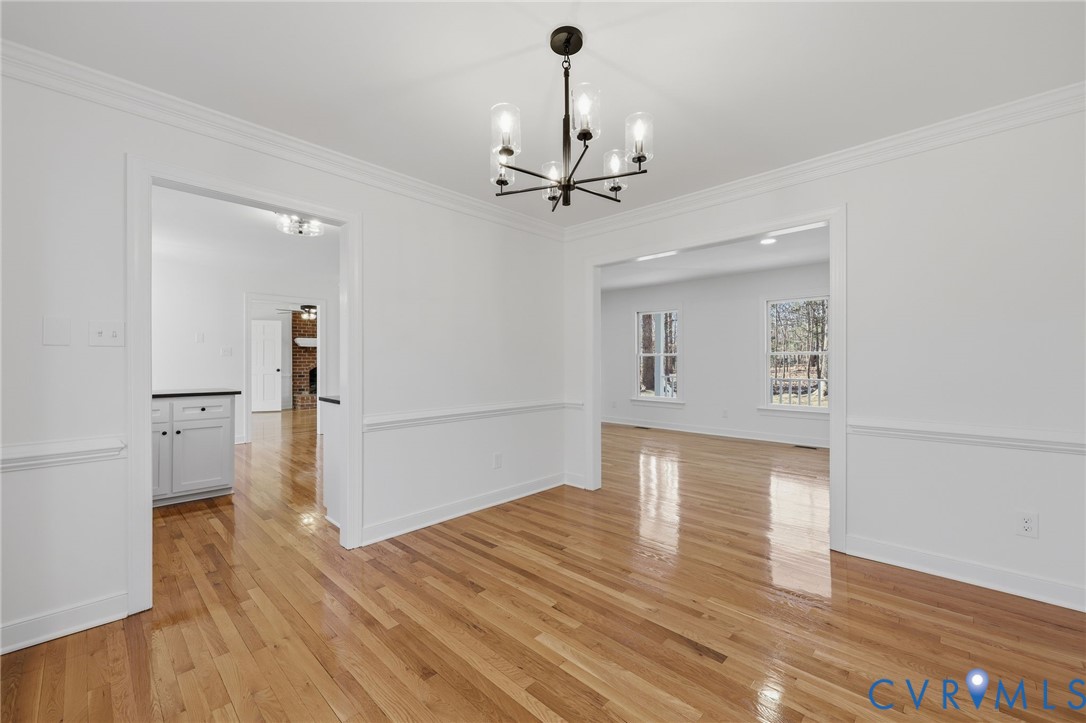 3264 Sherwood Ridge Way Powhatan, VA 23139 - Photo 10 of 40 a view of a livingroom with wooden floor a ceiling fan and kitchen space