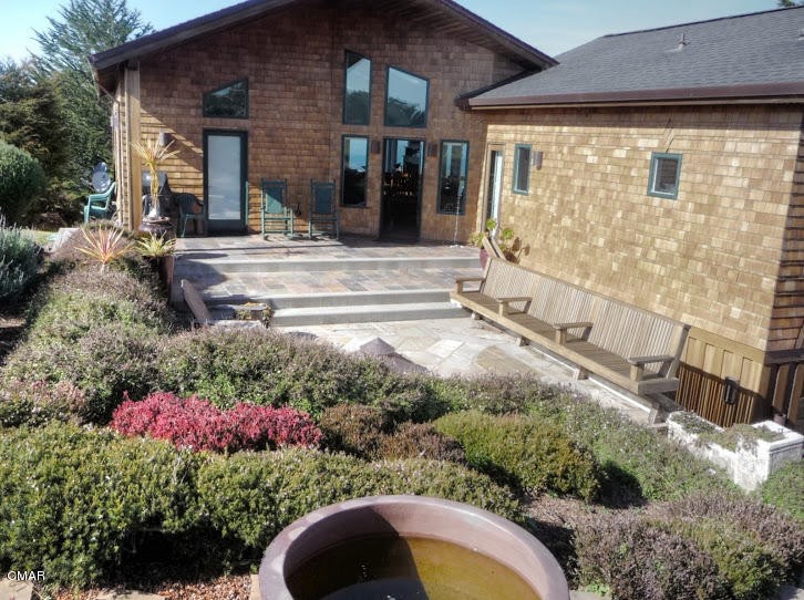 a view of a house with a flower garden