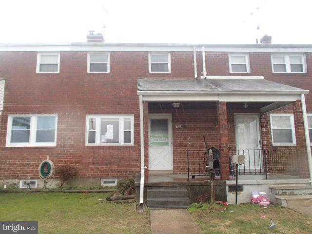 7651 Charlesmont Road Baltimore, MD 21222 - Photo 1 of 17 front view of a brick house with a yard