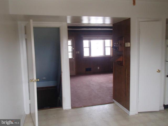 7651 Charlesmont Road Baltimore, MD 21222 - Photo 5 of 17 a view of a hallway with wooden shelves