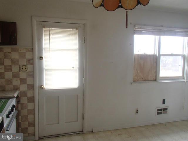 7651 Charlesmont Road Baltimore, MD 21222 - Photo 6 of 17 a bathroom with a window and a shower