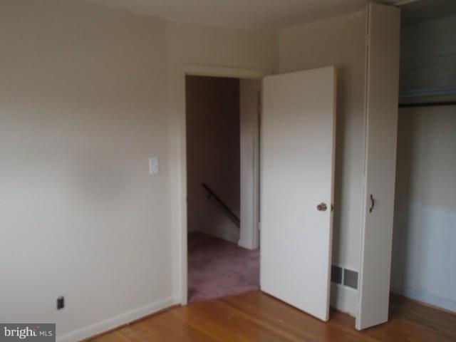 7651 Charlesmont Road Baltimore, MD 21222 - Photo 7 of 17 a view of a hallway with wooden floor