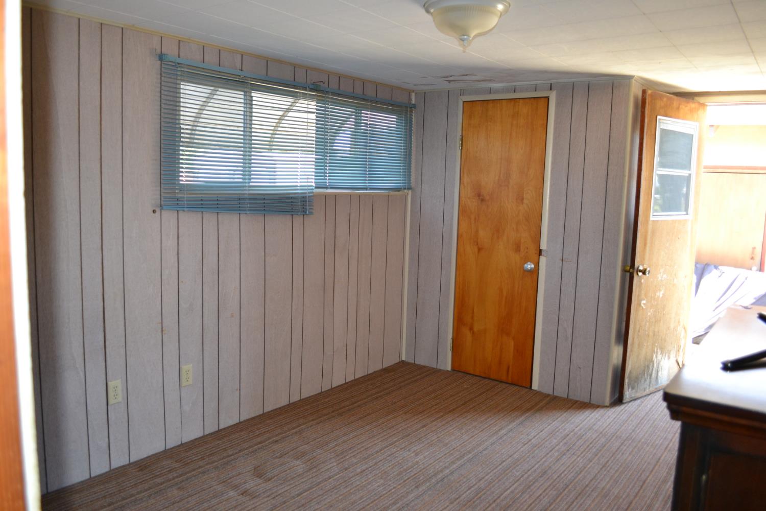 821 Orestimba Road Newman, CA 95360 - Photo 20 of 34 a view of an empty room with wooden floor and a window