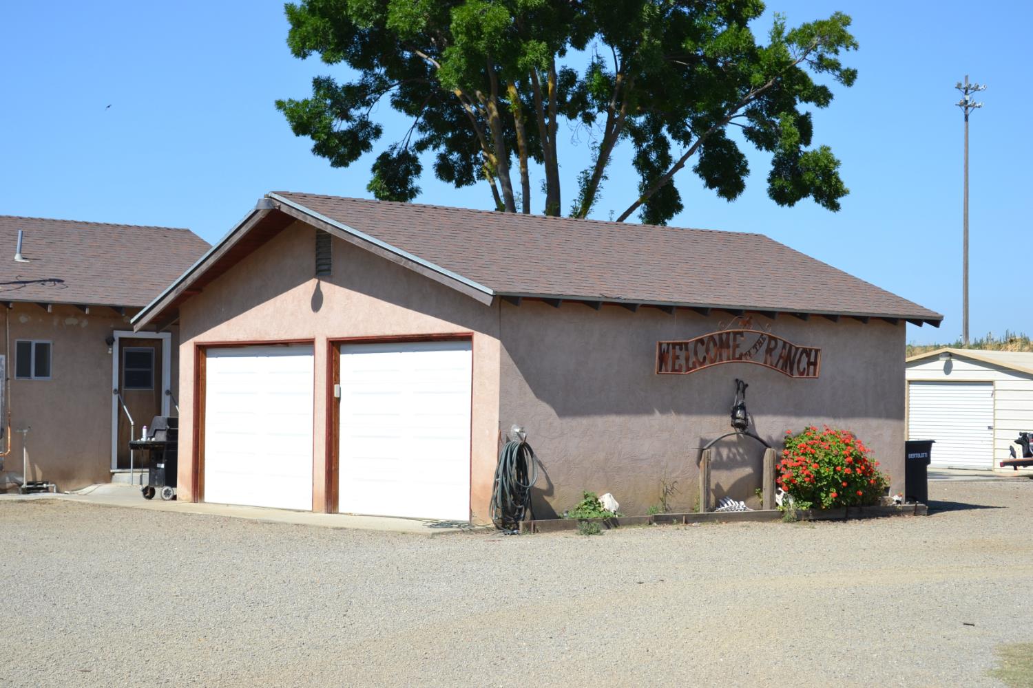 821 Orestimba Road Newman, CA 95360 - Photo 21 of 34 a view of a house with a yard and garage