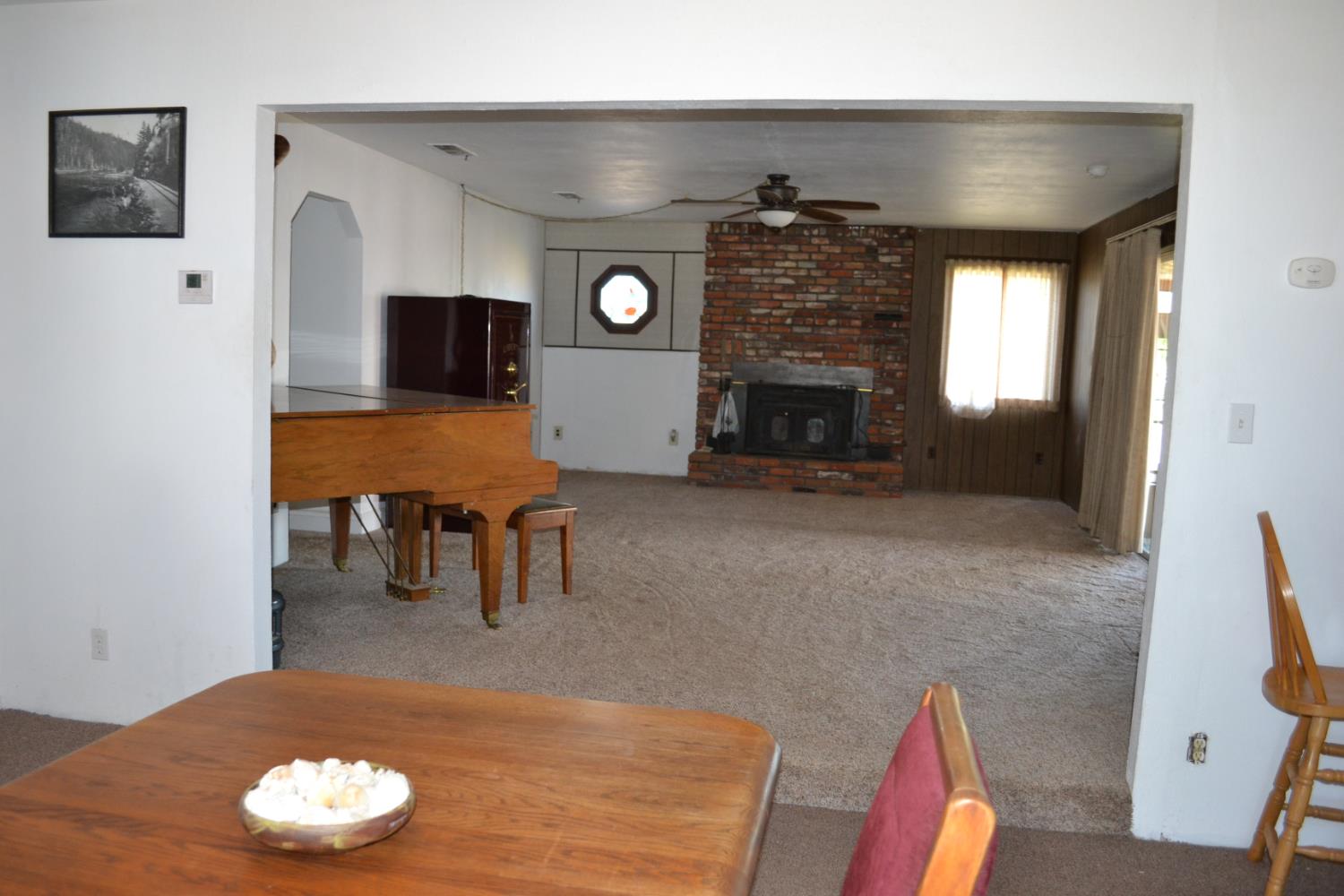 821 Orestimba Road Newman, CA 95360 - Photo 7 of 34 a living room with furniture and a fireplace