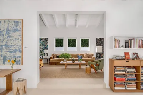 a living room with furniture and a book shelf