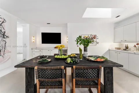 a table room with furniture and a flat screen tv