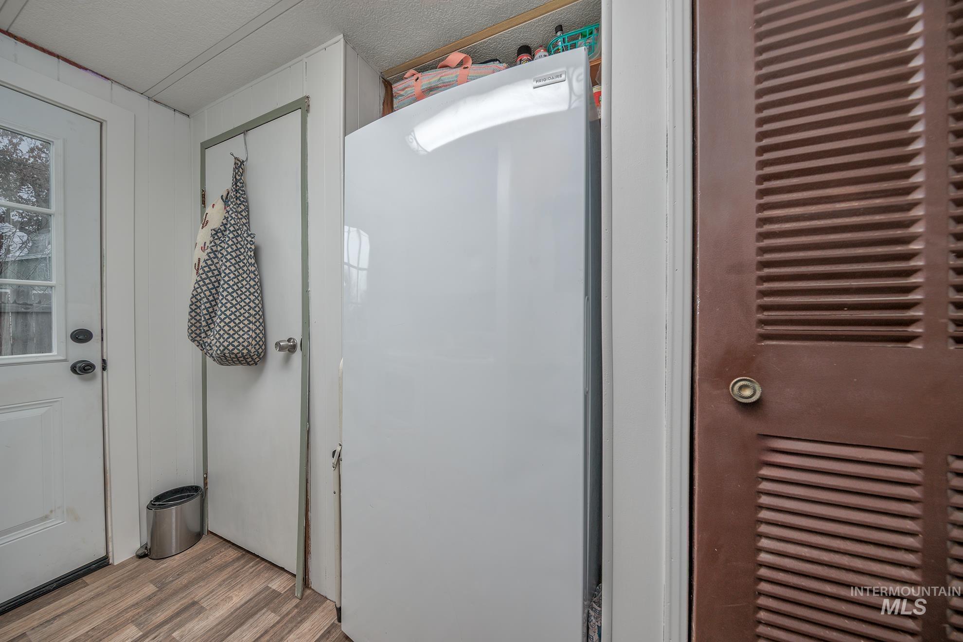 1165 Pioneer Road Weiser, ID 83672 - Photo 24 of 24 Detailed view of freestanding refrigerator and wood finished floors