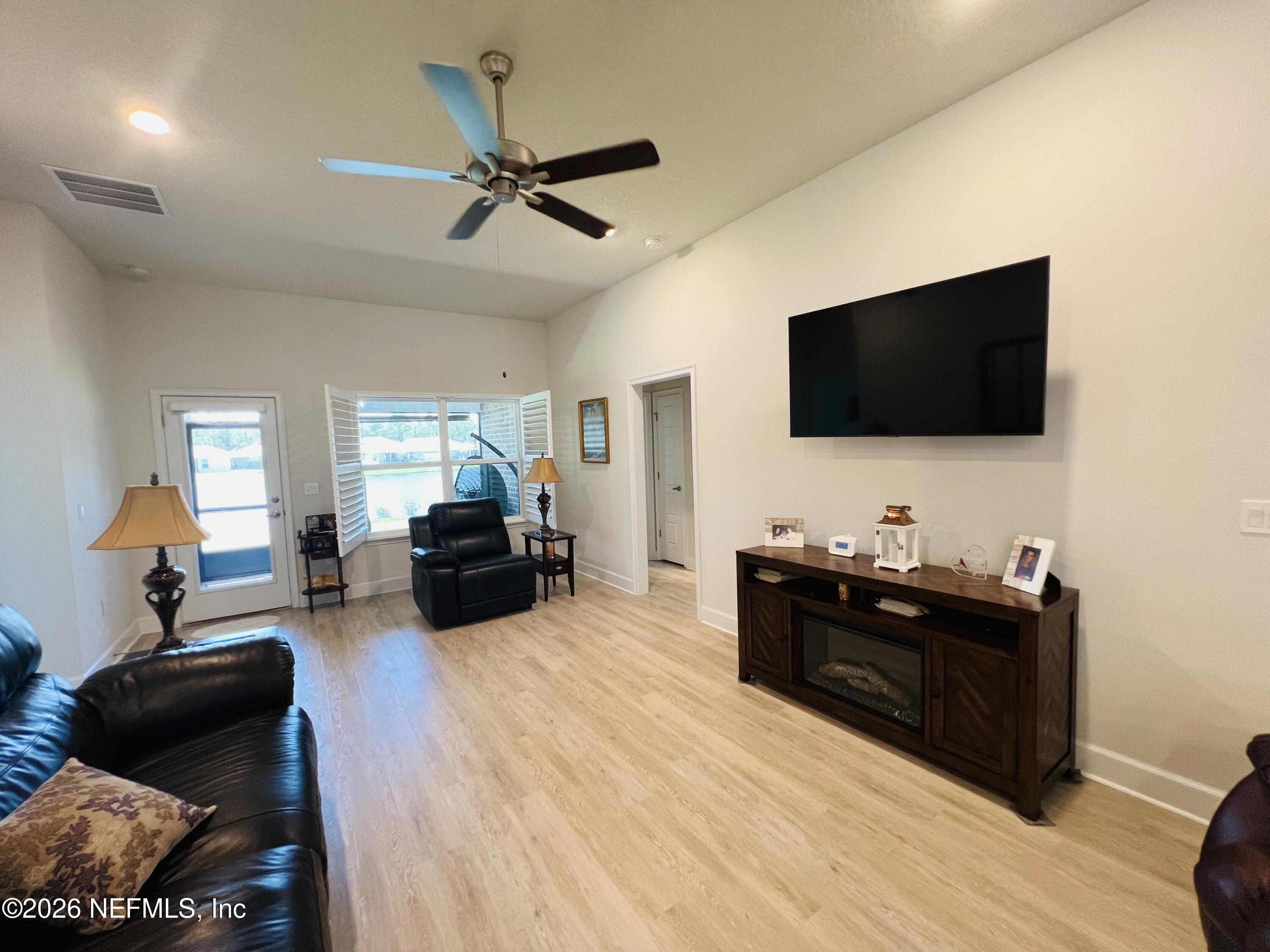 2 Rivertown Road Palm Coast, FL 32137 - Photo 52 of 80 a living room with furniture and a flat screen tv
