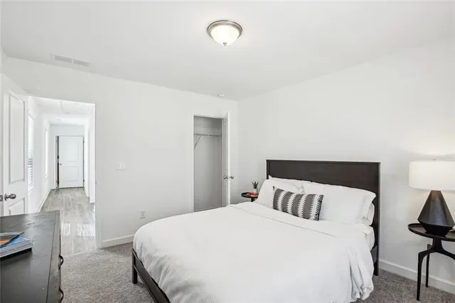 a bedroom with a bed and chair