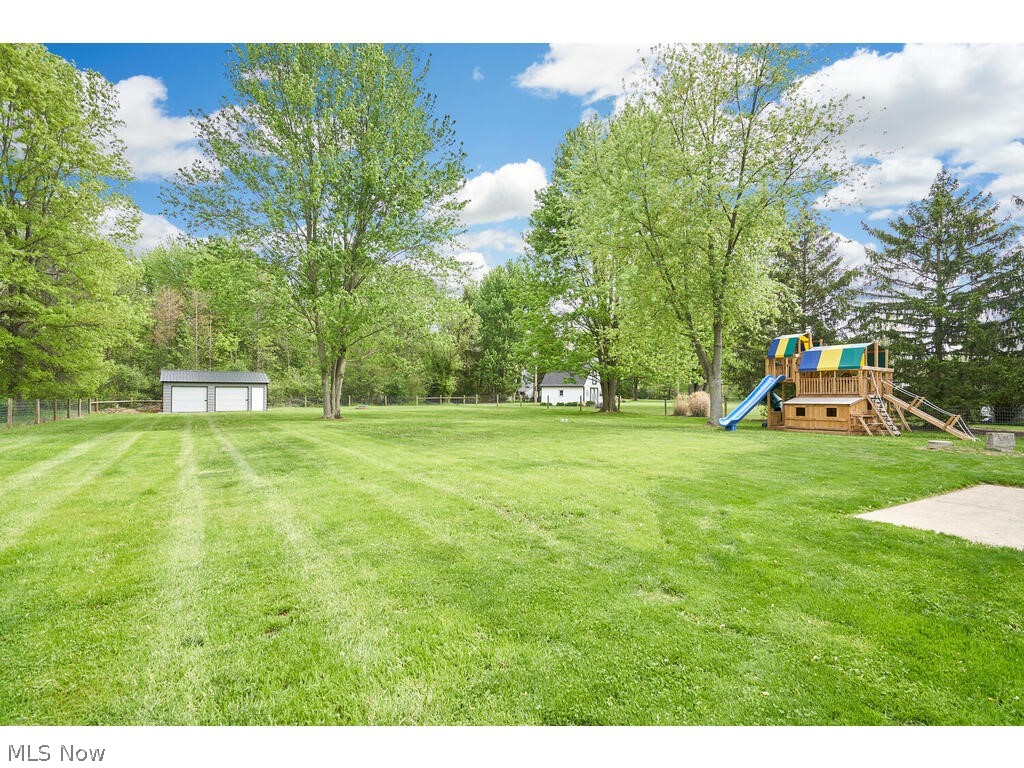 41780 Parsons Road Lagrange, OH 44050 - Photo 19 of 21 View of yard with an outdoor structure, a garage, and a playground