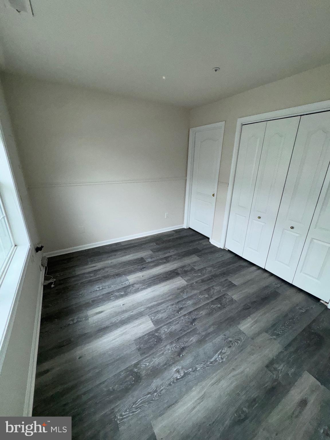 7705 Periwinkle Way, Unit 71 Severn, MD 21144 - Photo 3 of 28 a view of an empty room with a window