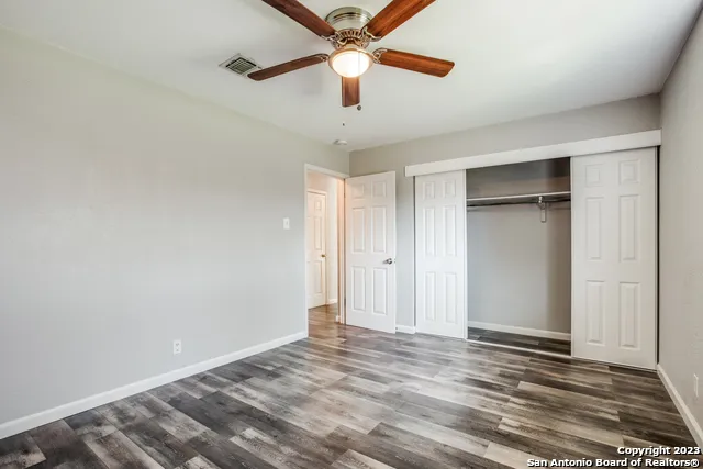 a view of empty room with ceiling fan