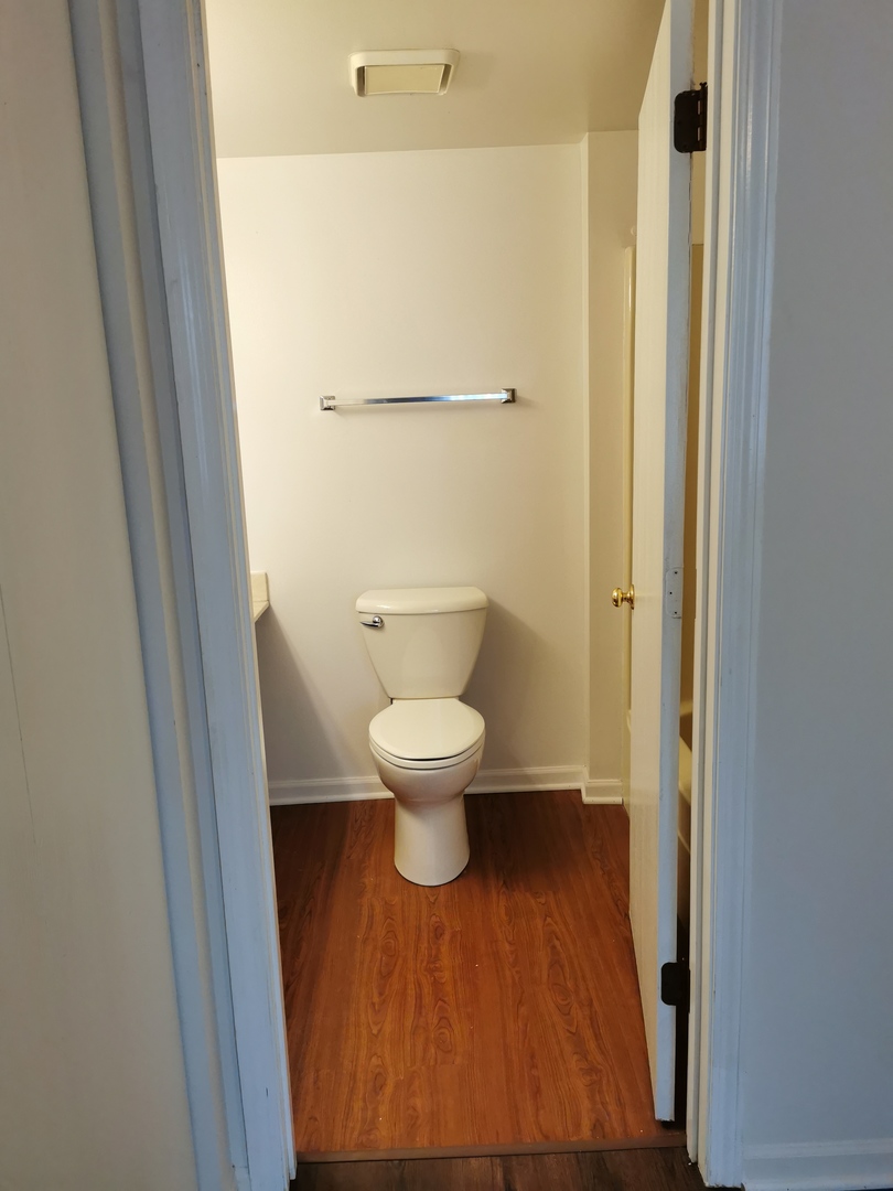 1424 Rock Run Drive, Unit B1 Crest Hill, IL 60403 - Photo 12 of 14 a bathroom with a toilet and a mirror