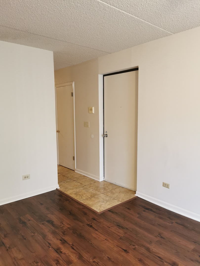 1424 Rock Run Drive, Unit B1 Crest Hill, IL 60403 - Photo 3 of 14 an empty room with wooden floor and closet