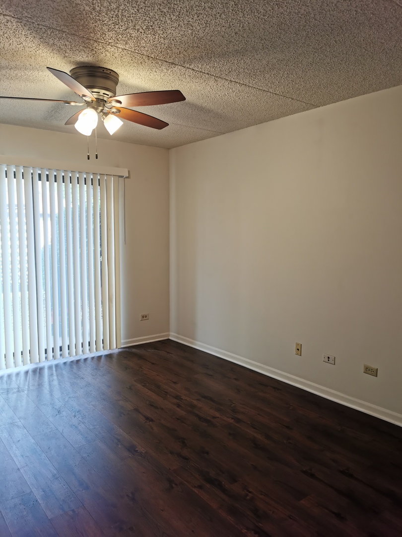 1424 Rock Run Drive, Unit B1 Crest Hill, IL 60403 - Photo 5 of 14 a view of an empty room with wooden floor