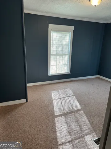 a room with granite countertop white cabinets and sink