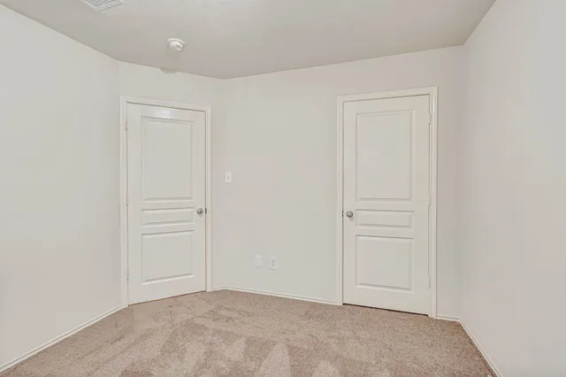 an empty room with closet area