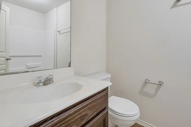 a bathroom with a sink toilet and vanity