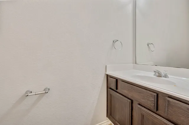 a bathroom with a sink and vanity