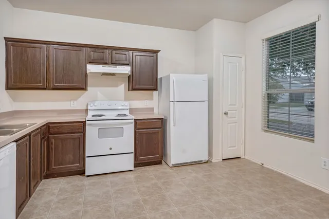 a kitchen with a stove and a refrigerator
