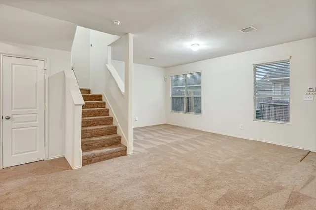 a view of an empty room with stairs