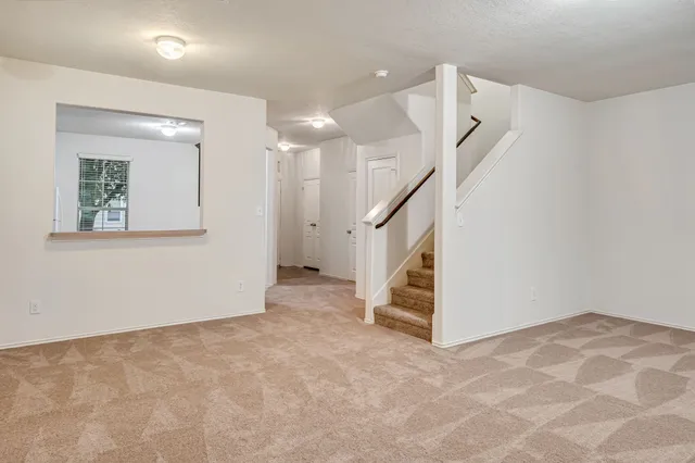 a view of an empty room with stairs