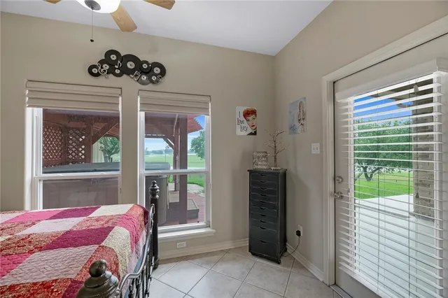 a bedroom with a bed and a large window