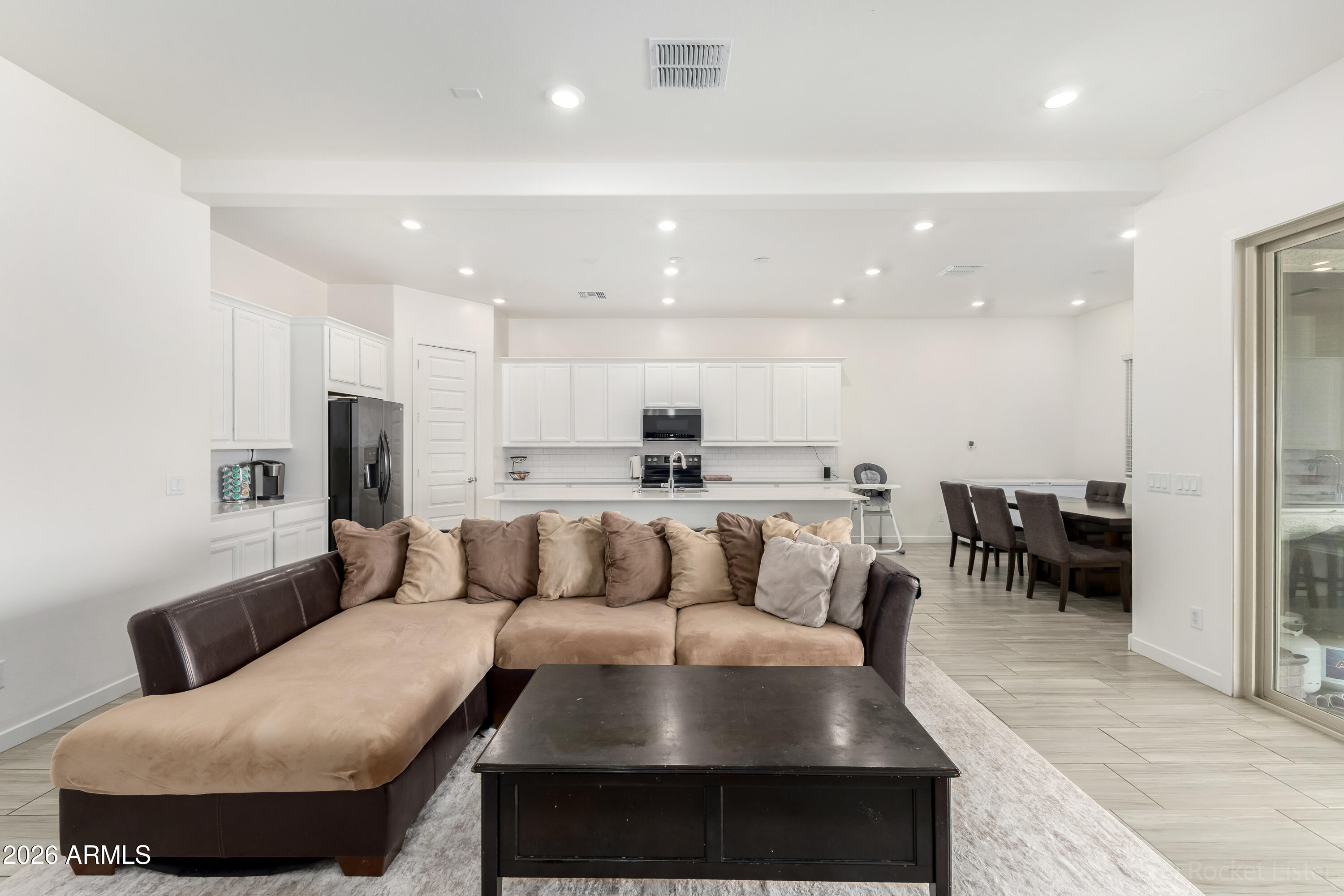 23929 North 166th Lane Surprise, AZ 85387 - Photo 6 of 23 a living room with furniture and a view of kitchen