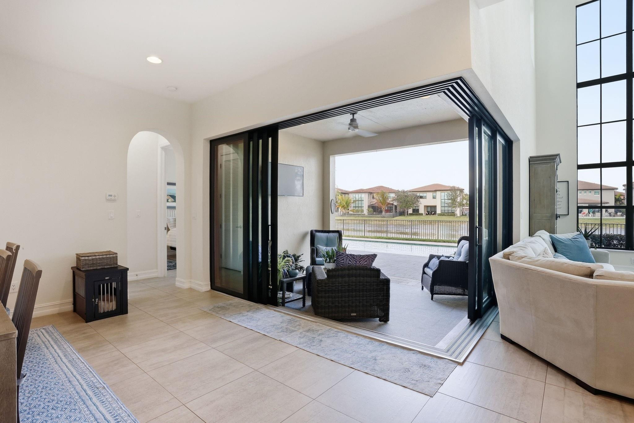 11585 Horizon Road Parkland, FL 33076 - Photo 16 of 91 a living room with furniture a large window and a flat screen tv