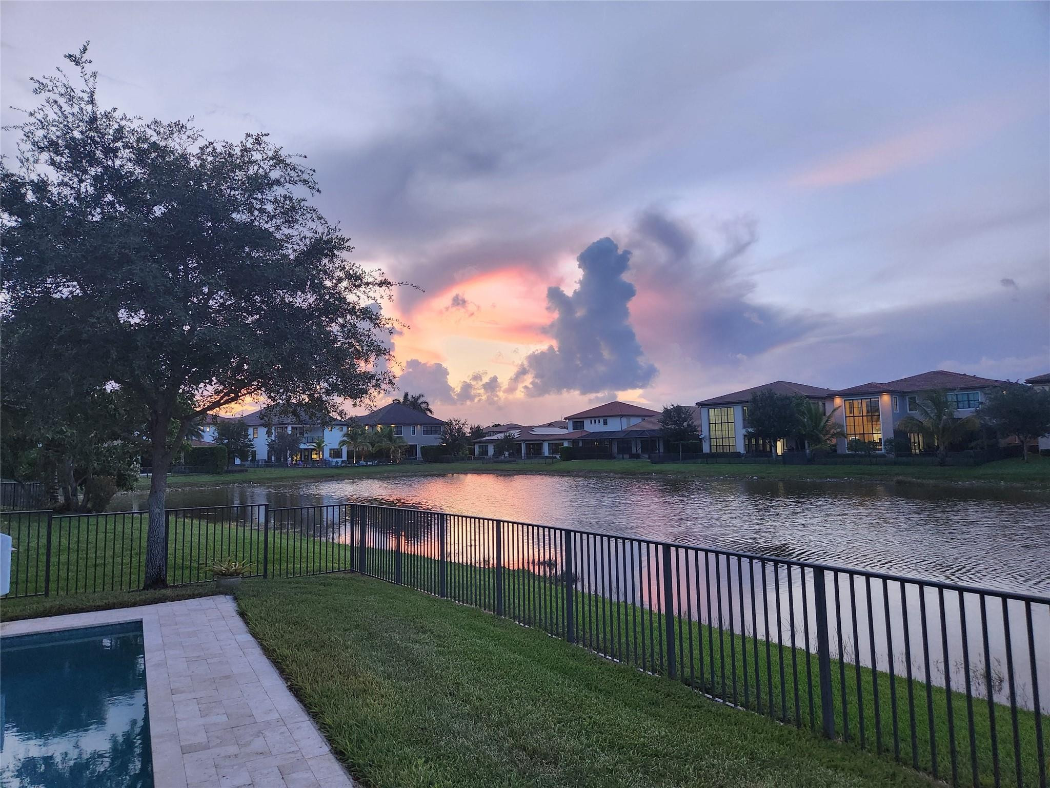 11585 Horizon Road Parkland, FL 33076 - Photo 49 of 91 a view of a lake with a garden and trees