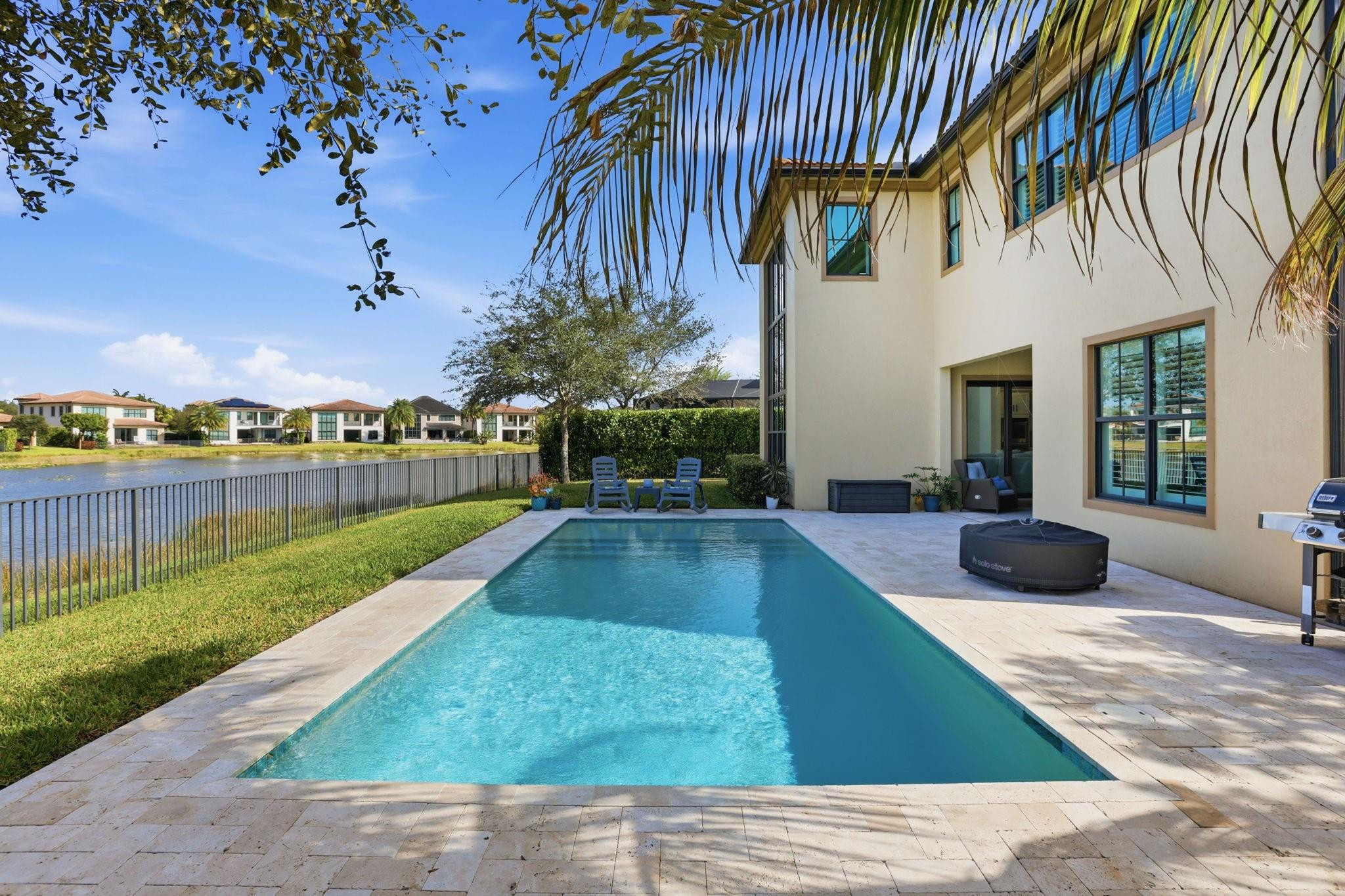 11585 Horizon Road Parkland, FL 33076 - Photo 51 of 91 a view of a house with a swimming pool and a yard