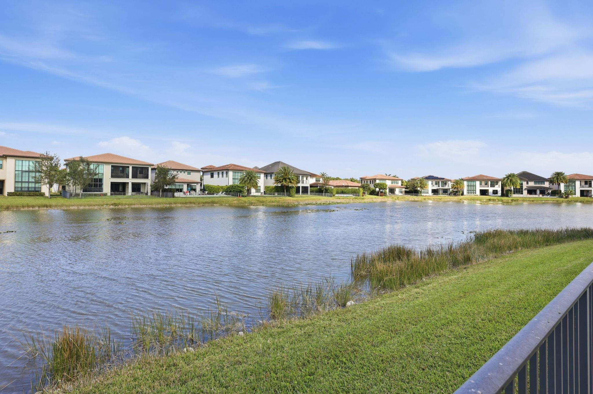 11585 Horizon Road Parkland, FL 33076 - Photo 52 of 91 a view of a lake with houses in the back