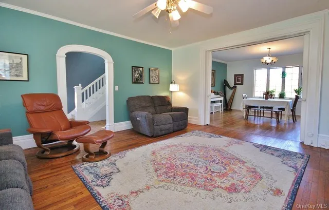 a living room with furniture and wooden floor