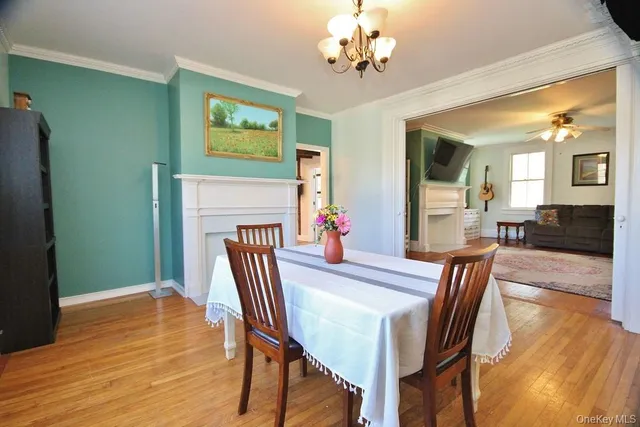 a view of a dining room with furniture wooden floor and a chandelier