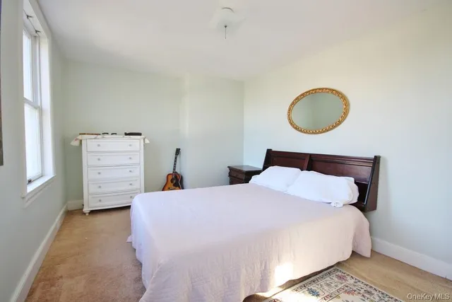 a bedroom with a bed and cabinet