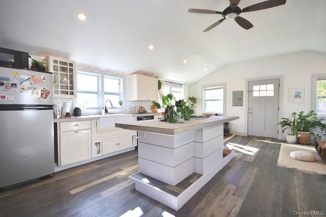 a kitchen with white cabinets and white appliances