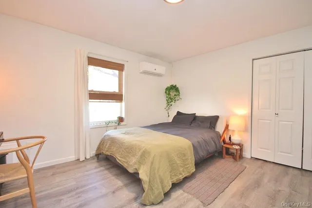 a bedroom with a bed a table and chair