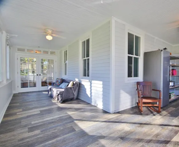 a living room with furniture window and wooden floor