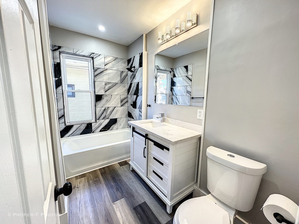 49 Hobson Street Springfield, MA 01109 - Photo 16 of 32 a bathroom with a sink a toilet and a mirror