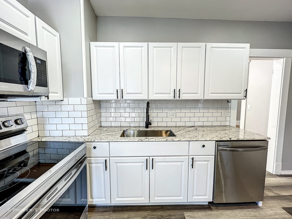 49 Hobson Street Springfield, MA 01109 - Photo 18 of 32 a kitchen with cabinets appliances and a sink