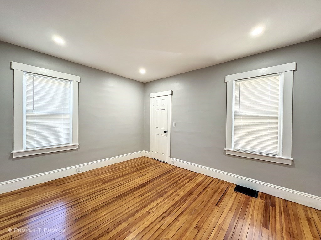49 Hobson Street Springfield, MA 01109 - Photo 24 of 32 an empty room with wooden floor and windows