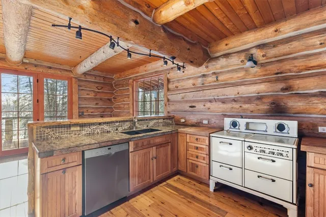 a kitchen with stove and cabinets