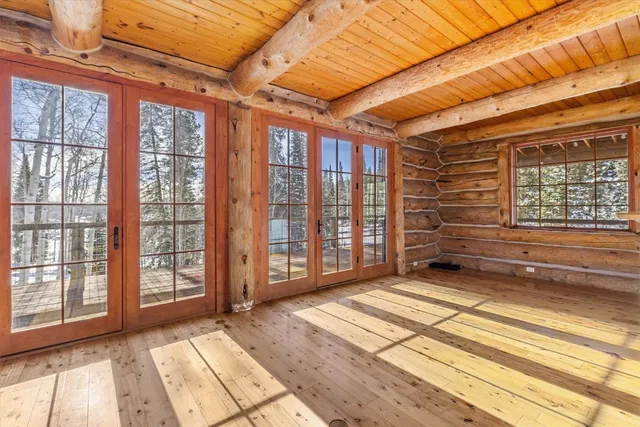 a view of a balcony with wooden floor and iron stairs