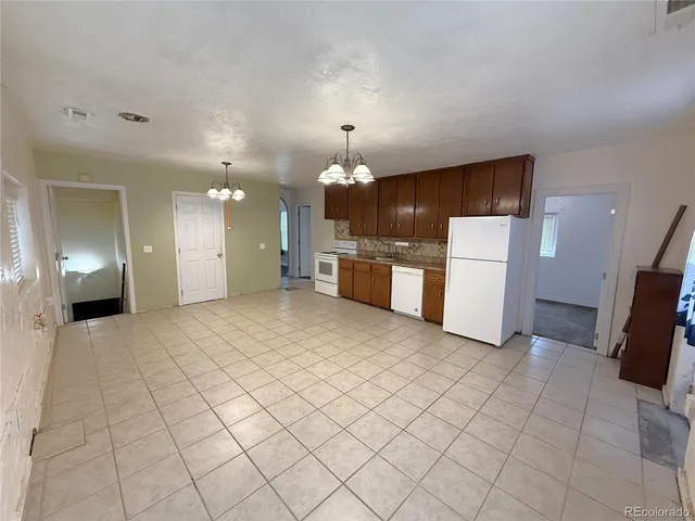 a kitchen with a stove a refrigerator and a oven