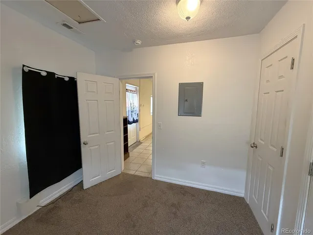 an empty room with wooden floor & entryway