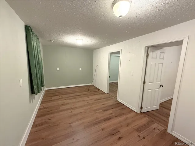 wooden floor in a hall with an empty room