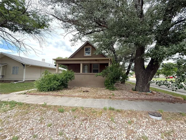 a front view of a house with a yard and a garage