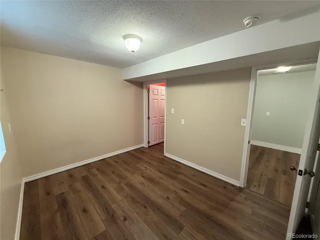 a view of a house with a yard and large tree